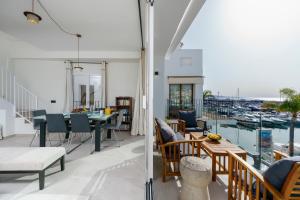 a room with a balcony with a table and chairs at 243-Fully Renovated-Puerto Banus Marbella Front Line Penthouse in Marbella