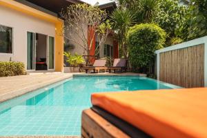 a swimming pool in front of a house at Siyada Villa in Lamai