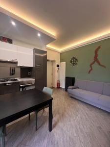 a living room with a couch and a table at Casa Concordia, near the station in Bellano