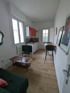 a living room with a couch and a table at Maisonnette avec petite cour in Bordeaux +16 photos