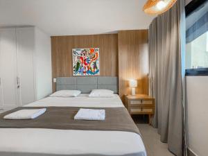 En eller flere senge i et værelse på Flat Elegante com Muito Estilo no Edificio Vertigo + 16 billeder