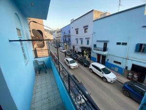 a view from a balcony of a street with cars at Casa Relax in Chefchaouen