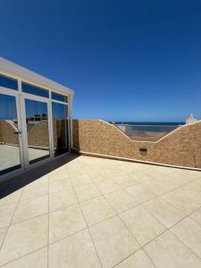 a large patio with a view of the ocean at Sea View Apartment in Mirleft