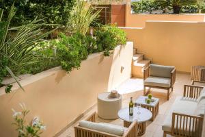 an outdoor patio with chairs and tables and plants at Deluxe Kefalonia Apartment Apartment Corali 3 Bedroom Pool Sea View Karavomilos in Karavomylos