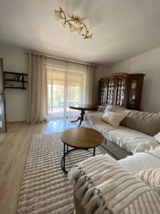 a living room with a couch and a table at Przystań u Bieszczadnika in Lutowiska