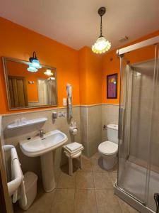 a bathroom with a sink and a toilet and a shower at Posada Soano in Soano