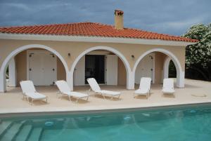 a house with chairs and a swimming pool at Luxury Zante Villa Zante Vista Villa Private Pool Seaviews Agios Sostis in Laganas +15 photos