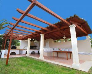 a wooden pergola on a patio with grass at Luxury Zante Villa Zante Vista Villa Private Pool Seaviews Agios Sostis in Laganas