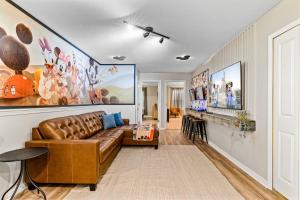 a living room with a brown leather couch at Brand New Charming Home 9 Miles To Disney in Orlando