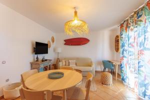 a living room with a table and a couch at Alma Ventura - A Peaceful Getaway in Majanicho in Majanicho