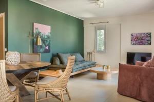 a living room with a couch and a table at Deluxe Kefalonia Apartment Apartment Noufaro 1 Bedroom Pool Sea View Karavomilos in Karavomylos