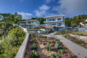 an image of a house with a garden at Super Luxury Skiathos Villa Seven Stunning Bedroom Suites Villa Levanta Achliades in Achladies