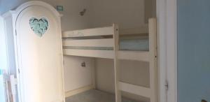 a bedroom with two bunk beds and a door at Torre marina in Riomaggiore