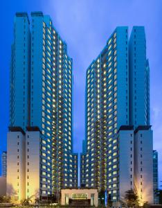 a group of tall buildings in a city at night at Horison Ultima Suite & Residences Rasuna Jakarta in Jakarta