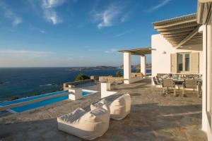 a villa with a view of the ocean at Platinum Paros Villa 3 Bedroom Villa Amazing Sea Views & Private Infinity Pool Access Parikia in Parasporos