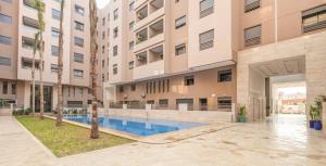 an apartment building with a swimming pool in a courtyard at 3 bedroom apartment in Marrakesh