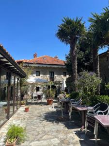 a patio with tables and chairs in front of a building at Posada Soano in Soano