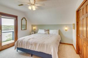 a bedroom with a bed with a ceiling fan and a window at Walk to Marina Water-View Dale Hollow Lake Escape in Celina