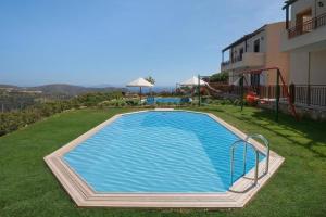 basen w trawie obok budynku w obiekcie Superior Crete Villa 2 Bedroom Villa Stefania Private Pool Sea View Triopetra w mieście Triopetra