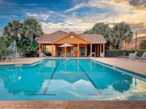 a house with a swimming pool in front of a house at Lovely 3bd Home With Bbq in Orlando