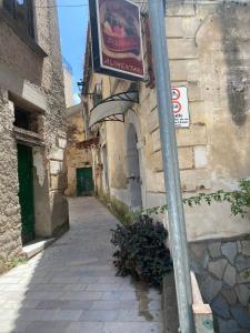a street sign on a pole next to a building at Casa Vacanze Centro Storico in Centola +7 photos