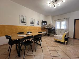 a living room with a table and chairs and a couch at Villa Marina in Torvaianica