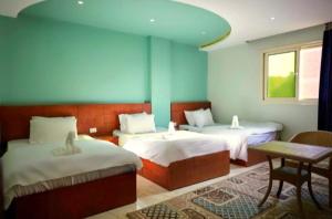 Voodi või voodid majutusasutuse Grand Golden Pyramids View Hotel toas