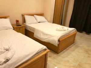 Voodi või voodid majutusasutuse Grand Golden Pyramids View Hotel toas