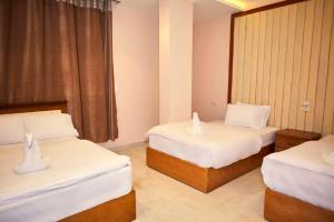 Voodi või voodid majutusasutuse Grand Golden Pyramids View Hotel toas