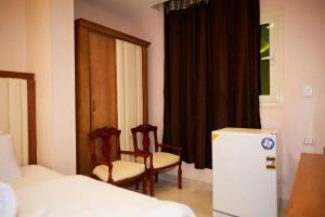 Voodi või voodid majutusasutuse Grand Golden Pyramids View Hotel toas