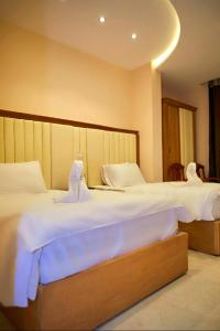 Voodi või voodid majutusasutuse Grand Golden Pyramids View Hotel toas