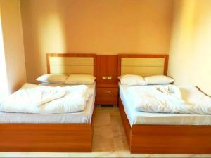 Voodi või voodid majutusasutuse Grand Golden Pyramids View Hotel toas