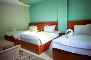 Voodi või voodid majutusasutuse Grand Golden Pyramids View Hotel toas