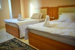 Voodi või voodid majutusasutuse Grand Golden Pyramids View Hotel toas