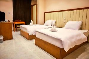 Voodi või voodid majutusasutuse Grand Golden Pyramids View Hotel toas