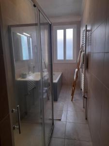 a bathroom with a glass shower and a sink at Double room, in an elegant house, Thuir centre, terraces view Canigou in Thuir