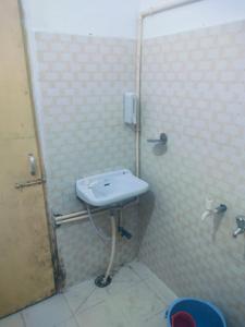 a bathroom with a sink and a shower at Sakhambari Nitya Anandan Ashram in Varanasi