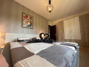 two swans are sitting on top of a bed at Къща за гости, Guesthouse GOTINOTO in Krapets +57 photos