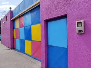 a colorful building with a door in front of it at Hotel Cano in Iquique