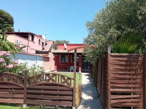 a wooden fence in front of a house at Luce di Mare in Quartu SantʼElena