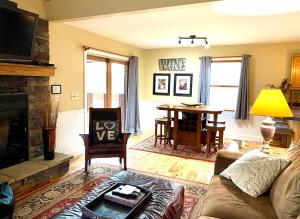 a living room with a couch and a table at Couples Paradise I - by The Chalets in Logan