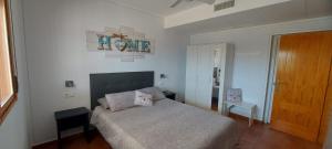 a bedroom with a bed and a wooden door at Cortijo Blanco in Albondón