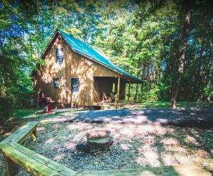 a log cabin with a pot in front of it at Couples Paradise II - by The Chalets in Logan