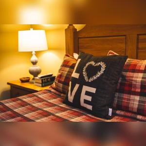 a bed with a pillow with the word me on it at Couples Paradise II - by The Chalets in Logan