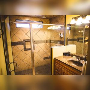 a bathroom with a shower and a sink at Couples Paradise II - by The Chalets in Logan +36 photos