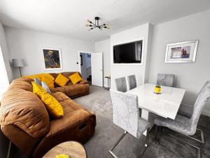 a living room with a couch and a table at Mill House Retreat in Leslie