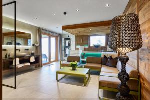 a living room with a couch and a table at Fender Chalets Sonnalm Luxury Homes in Gmünd in Kärnten