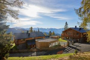 an image of a house with mountains in the background at Fender Chalets Sonnalm Luxury Homes in Gmünd in Kärnten