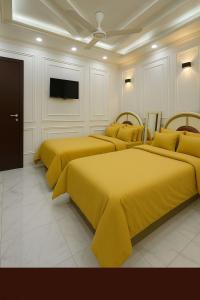 a group of four beds in a room at Porto Said Family Spot in Port Said