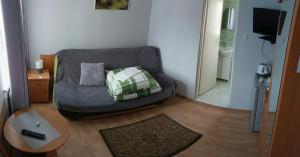 a living room with a couch and a table at DW FALA in Rewal